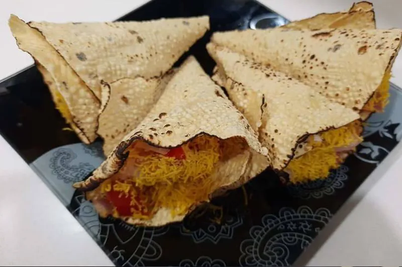 Roasted papad topped with chopped onion, tomato and coriander